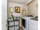 Functional laundry room with modern washer and dryer, storage shelves, and decorative wall art at 3016 Hanson Dr, Charlotte, NC 28207