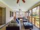 Relaxing screened porch featuring comfortable seating, ceiling fans, and access to the outdoors at 3016 Hanson Dr, Charlotte, NC 28207
