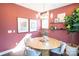 Cozy dining room features a round table, modern lighting, decorative prints, and a lush potted plant at 317 Old Town Village Rd, Waxhaw, NC 28173
