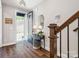 Inviting foyer with hardwood floors, staircase, accent table, and an open view to the outdoors at 317 Old Town Village Rd, Waxhaw, NC 28173