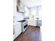 Modern kitchen features stainless steel appliances, a large range hood, white cabinets, and a subway tile backsplash at 317 Old Town Village Rd, Waxhaw, NC 28173
