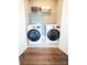 Efficient laundry room with modern washer and dryer units, complemented by stylish black and white flooring at 317 Old Town Village Rd, Waxhaw, NC 28173