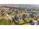 Wide angle aerial view of a neighborhood with manicured lawns, mature trees and well maintained homes at 3907 Voltaire Dr, Monroe, NC 28110