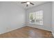 Bedroom featuring hardwood floors, light walls, ceiling fan and large window at 3907 Voltaire Dr, Monroe, NC 28110