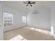 Spacious bedroom with vaulted ceiling and large windows, neutral carpet and ceiling fan at 3907 Voltaire Dr, Monroe, NC 28110
