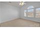 Cozy bedroom featuring carpet floors, a ceiling fan, and natural light at 3907 Voltaire Dr, Monroe, NC 28110