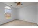 Bright bedroom featuring a window, ceiling fan and neutral carpet at 3907 Voltaire Dr, Monroe, NC 28110