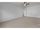 Spacious bedroom featuring neutral carpet, ceiling fan and large closet at 3907 Voltaire Dr, Monroe, NC 28110