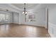 Bright dining room featuring hardwood floors, wainscoting, and a large window at 3907 Voltaire Dr, Monroe, NC 28110