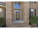 Elegant front entrance with a large window above the door and brick accents at 3907 Voltaire Dr, Monroe, NC 28110