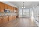 Bright kitchen with an island, stainless steel appliances, and hardwood floors at 3907 Voltaire Dr, Monroe, NC 28110