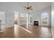 Bright living room featuring hardwood floors, a fireplace, and arched windows at 3907 Voltaire Dr, Monroe, NC 28110