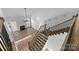 Open floor plan with hardwood floors, fireplace, and staircase with wooden and wrought iron railing at 3907 Voltaire Dr, Monroe, NC 28110