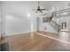 Bright, open living space with a staircase, hardwood floors, and vaulted ceilings at 3907 Voltaire Dr, Monroe, NC 28110