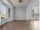 Inviting living room features hardwood floors, large windows, and natural light at 3907 Voltaire Dr, Monroe, NC 28110