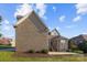 Back exterior featuring brick, patio, and lawn at 3907 Voltaire Dr, Monroe, NC 28110