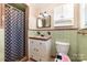 Traditional bathroom with a shower, a vintage sink, and green and brown patterned tile at 401 Dakota St, Kannapolis, NC 28083