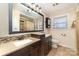 Bathroom featuring dual sinks, tile backsplash, and a large mirror at 401 Dakota St, Kannapolis, NC 28083