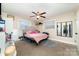 Bedroom with light walls, carpeted floor, ceiling fan, and two windows for natural light at 401 Dakota St, Kannapolis, NC 28083