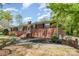 Charming red brick home with manicured landscaping, black shutters, and a welcoming front entrance at 401 Dakota St, Kannapolis, NC 28083