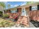 Front of the house featuring a brick facade, front stairs, and small garden and lawn at 401 Dakota St, Kannapolis, NC 28083