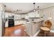 Bright kitchen boasts granite counters, white cabinets, breakfast bar, and stainless steel appliances at 401 Dakota St, Kannapolis, NC 28083