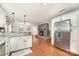 Open kitchen area with granite countertops, fireplace, stainless steel refrigerator, and hardwood floors at 401 Dakota St, Kannapolis, NC 28083