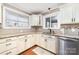 Well-lit kitchen features granite countertops, white cabinets, stainless steel appliances, and tiled backsplash at 401 Dakota St, Kannapolis, NC 28083