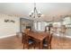 Open-concept living room and dining area features a cozy fireplace, hardwood floors, and ample natural light at 401 Dakota St, Kannapolis, NC 28083