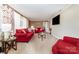 Cozy living room featuring plush red couches and natural light from the white-curtained window at 401 Dakota St, Kannapolis, NC 28083