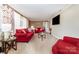 Cozy living room with neutral paint, bright red sofas, lots of natural light, and plush carpeting at 401 Dakota St, Kannapolis, NC 28083