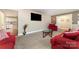 Relaxing living room featuring comfortable red sofas and an open view of the eat-in kitchen at 401 Dakota St, Kannapolis, NC 28083