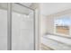 Well-lit bathroom showcasing a glass shower and soaking tub with a large window at 4055 10Th Avenue Sw Dr, Hickory, NC 28602