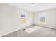 Carpeted bedroom showcasing two large windows that provide ample natural light at 4055 10Th Avenue Sw Dr, Hickory, NC 28602