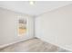 A bright, well-lit bedroom with wood-look floors and a large window at 4055 10Th Avenue Sw Dr, Hickory, NC 28602