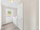 Bright laundry room with white appliances, ample storage, and exterior access to yard at 4055 10Th Avenue Sw Dr, Hickory, NC 28602