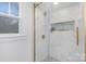 Luxurious bathroom shower featuring white marble tile, glass door, and rain shower head at 437 Chadmore Dr, Charlotte, NC 28270