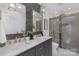Modern bathroom with double vanity, marble countertops, and a glass-enclosed shower at 437 Chadmore Dr, Charlotte, NC 28270