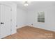 Bright bedroom with hardwood floors, natural light from the window, and white paneled door at 437 Chadmore Dr, Charlotte, NC 28270