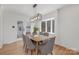 Bright dining room with modern lighting and a view of the backyard at 437 Chadmore Dr, Charlotte, NC 28270