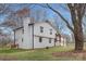 Two-story white brick home with gabled roof, chimney, and inviting front porch at 437 Chadmore Dr, Charlotte, NC 28270