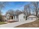 Beautifully renovated white brick home with a detached two-car garage and new concrete driveway at 437 Chadmore Dr, Charlotte, NC 28270