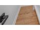Hallway with light wood floors, white walls, and a black door handle at 437 Chadmore Dr, Charlotte, NC 28270