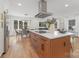 Expansive kitchen with a large island, dining area, stainless steel appliances and hardwood floors at 437 Chadmore Dr, Charlotte, NC 28270