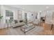 Cozy living room with neutral tones, large windows, and ample natural light at 437 Chadmore Dr, Charlotte, NC 28270