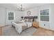 Serene main bedroom with plush bedding and natural light from large windows at 437 Chadmore Dr, Charlotte, NC 28270