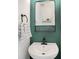 Stylish powder room featuring a modern sink, black fixtures, decorative mirror and elegant green walls at 464 Hurston Cir, Charlotte, NC 28208