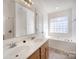 Bright bathroom featuring double sinks, garden tub, and window offering natural light at 464 Hurston Cir, Charlotte, NC 28208