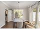 Bright dining area featuring hardwood floors, a modern light fixture, and backyard access at 464 Hurston Cir, Charlotte, NC 28208