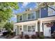 Charming townhome with a covered front porch, white trim, and a beautifully landscaped yard at 464 Hurston Cir, Charlotte, NC 28208